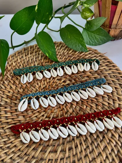 I love creating these boho shell anklets, available in green, blue, and red. Each one is knotted with natural cowrie shells and tiny brass beads, perfect for a beach vacation or adding a free spirited vibe to your look.