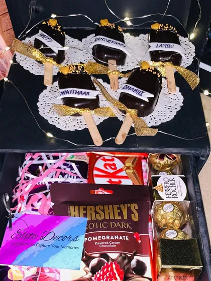 This is another view of the surprise box, showing how it can be customized with treats like personalized cakesicles on top for an extra layer of surprise.