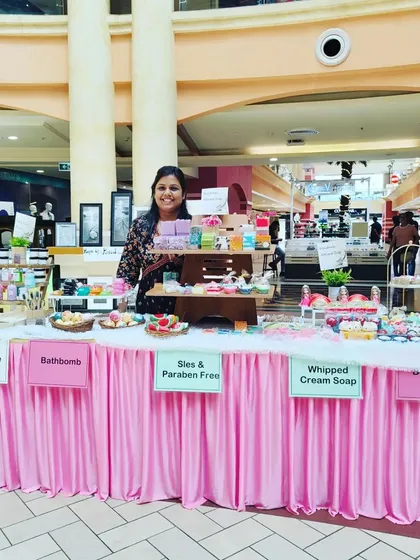 Holding up a gift box at my stall. I love helping customers pick out the perfect handmade gift.