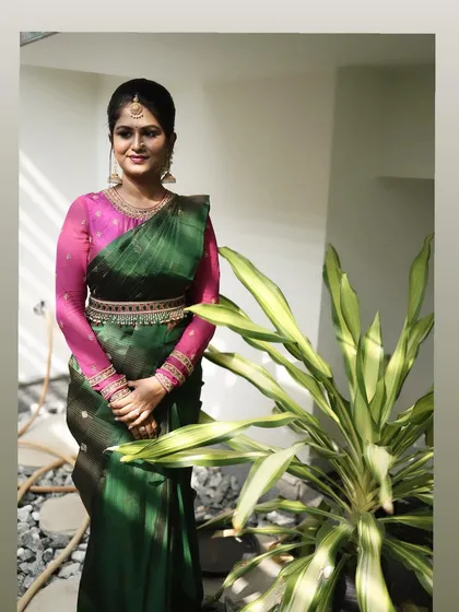A full-length shot of Dr. Meghana's pre-wedding ritual look. The makeup is classic and enhances her beautiful features.
