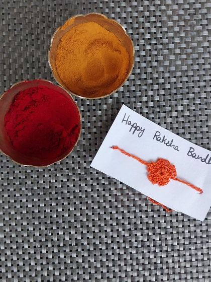 A tiny flower rakhi, perfect for a baby's first Raksha Bandhan or for someone who loves delicate designs.