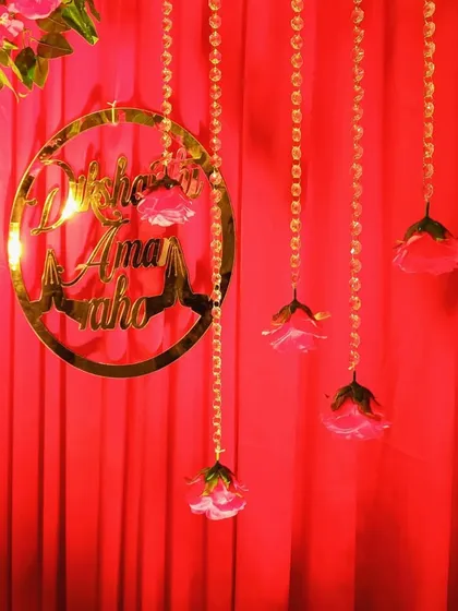Another angle of the custom hoop, showing how it hangs against the red curtain backdrop with delicate hanging rose details.