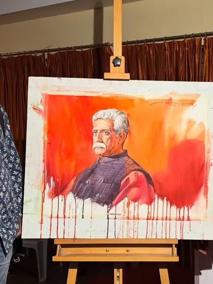 Standing with the completed 22"x30" watercolour portrait and an attendee at the Nashik event.