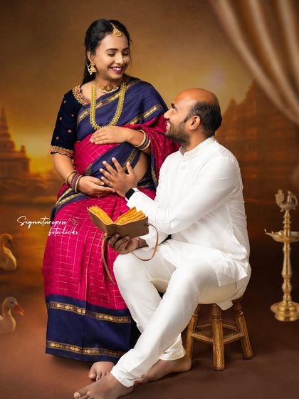 A beautiful moment between a couple, where traditional attire meets shared anticipation in a temple-themed setting.