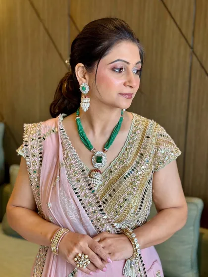 A side profile of the mother of the groom. Her makeup is elegant and sophisticated, with a focus on enhancing her graceful features.