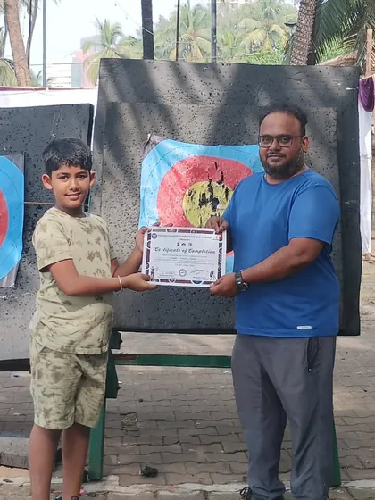 A young archer from the November batch proudly accepts his certificate. It's great to see kids developing a passion for the sport.