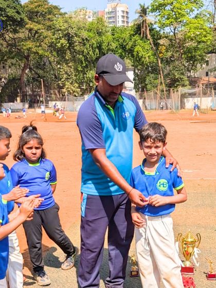 A coach presenting a medal to a young player. These moments of individual recognition are crucial for building confidence.