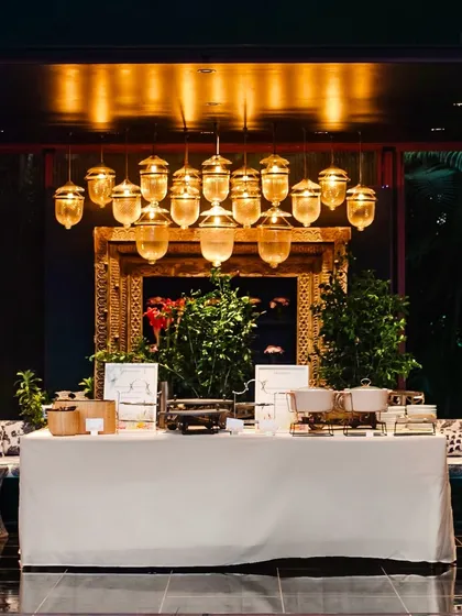 A simple, elegant buffet setup under beautiful golden lighting, ready for service.