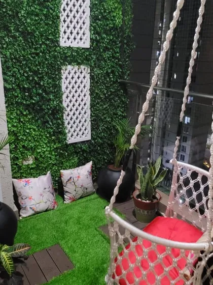 There's something magical about a cozy balcony at night. For this space, I added a soft macrame swing, artificial grass for comfort, and a vertical garden wall. It’s now the perfect little nook for the kids to play or for a quiet evening.