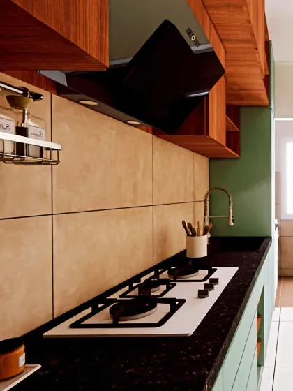 A close-up of the kitchen countertop, showing the sleek hob and modern chimney. The design prioritizes functionality and ease of use in a compact footprint.