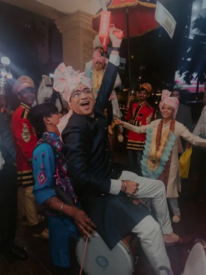 The baraat isn't just for the groom. We make sure the whole family, like this guest on the dhol, is part of the high-energy celebration.