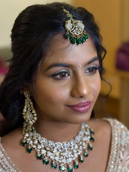 A close-up of Deekshida's bold reception glam. The holographic green glitter liner adds a striking and unique touch to her eye makeup.