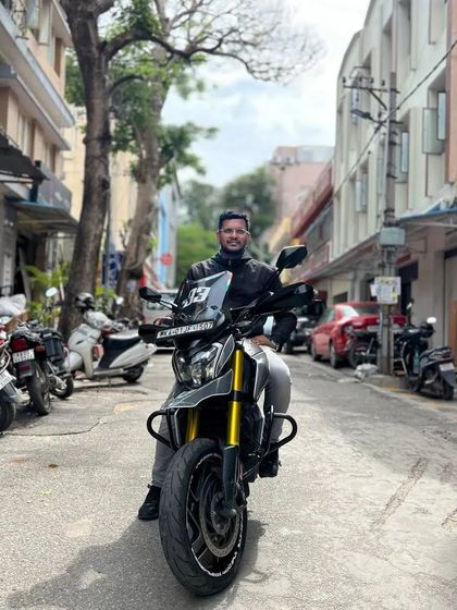 A rider on his Dominar 400 Supermoto build in a Bengaluru alley. This bike is modified for agility and a commanding presence.