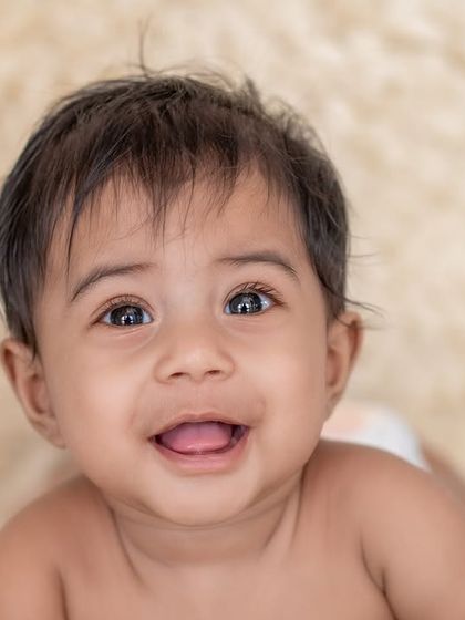 A bright and happy close-up of a baby's smiling face. These simple shots are perfect for capturing their personality.