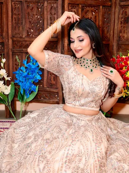 A playful shot of a model in the beige and silver lehenga, showing how comfortable and easy to wear my rental outfits are.