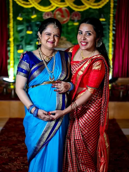 Two women sharing a happy moment at a maternity function. Capturing these connections between family and friends is a key part of my event photography service.