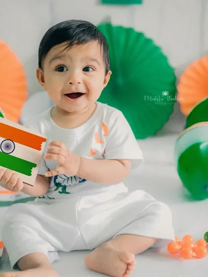 A big, happy smile for India. This little one is full of joy during his Independence Day themed photoshoot.