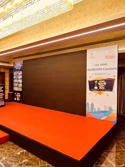 A side view of the stage setup for the All India Achievers Conclave, showing the branded podium and side panels. We ensure consistent branding across all event elements for a cohesive and professional look.