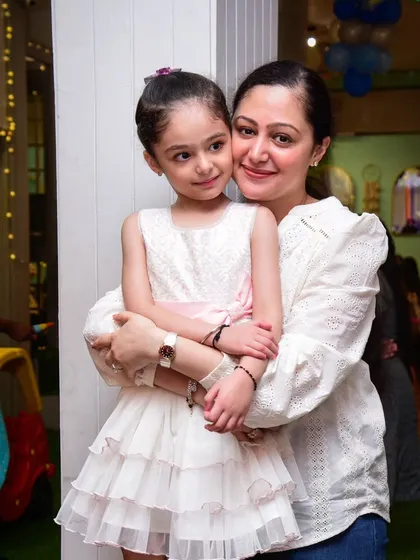 A beautiful mother-daughter moment, full of love and affection.