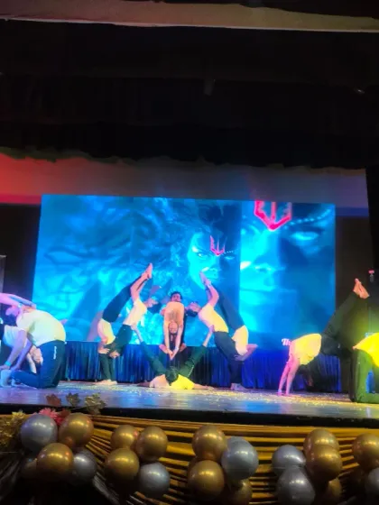 A glimpse from our students' yoga performance at the Shah Auditorium during a Holi celebration. This complex formation shows the blend of artistry and athleticism in acro yoga.