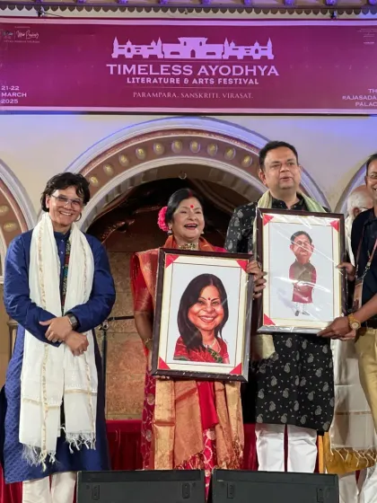 On stage at the Timeless Ayodhya Festival, presenting caricatures to Malini Awasthi ji and other dignitaries.