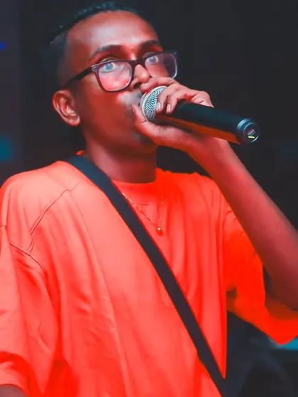 Rocking an orange shirt for an 'Asian Night' event. I always bring my A-game, whether it's a hip-hop show or a multi-genre cultural party.