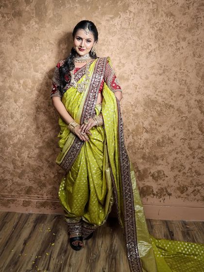 A unique lime green Nauvari with a red blouse, a fresh and eye-catching combination for any celebration.
