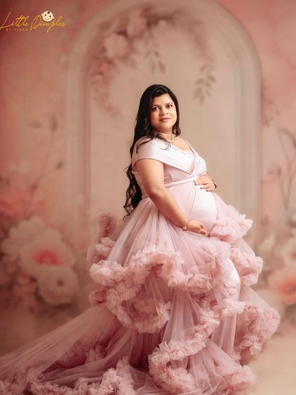 This ruffled pink gown is a favorite among my clients. It brings so much texture and romance to a maternity portrait, especially against a soft, floral backdrop.