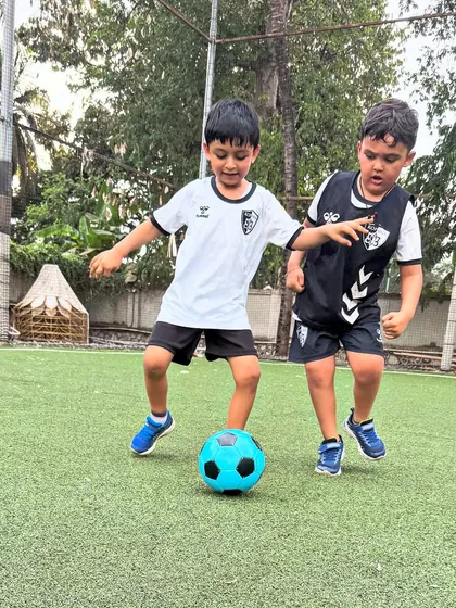 Two players are locked in a one-on-one battle for the ball, a common scenario in our training that builds resilience and defensive skills.