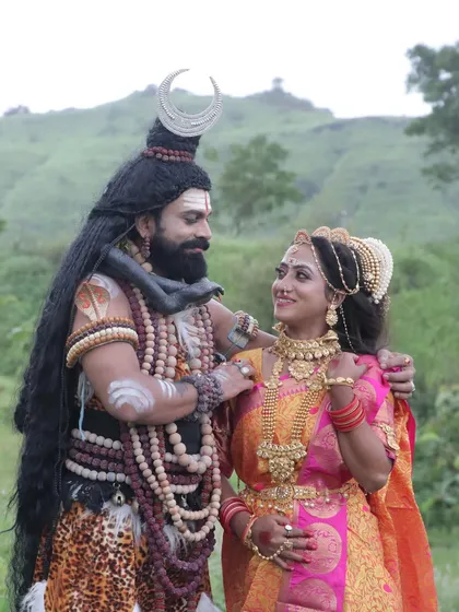 A serene moment between the divine couple. This highlights the subtle expressions and the makeup's ability to convey emotion, a key skill in character artistry.