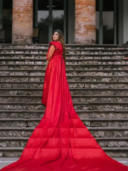 A full view of the magnificent quilted trail on this red gown. The detachable sleeves have been removed here, showcasing a different style for this versatile rental piece.