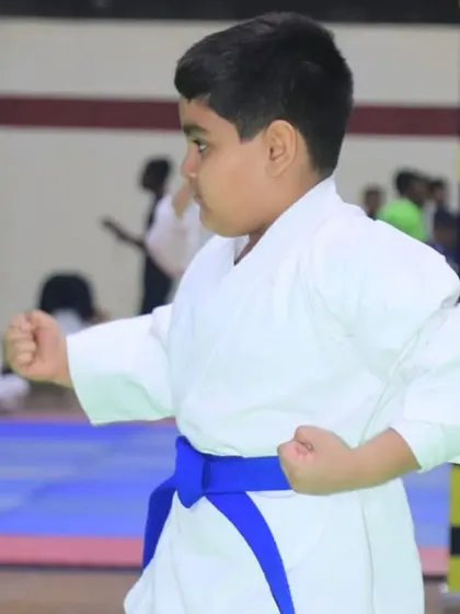 A young karateka demonstrates his form during a competition. We provide a platform for athletes of all ages to develop their skills, build confidence, and compete in a supportive environment.