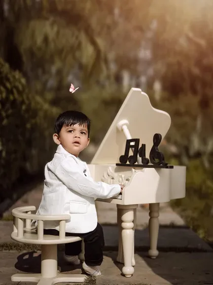 A moment of magic with a butterfly. This little pianist looks up in wonder, creating a beautiful and whimsical photograph.