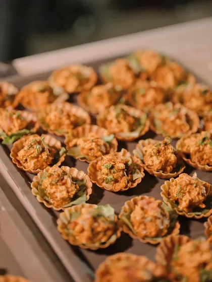 A tray of our Chicken Tikka Salad Canapés, ready to be served. The creamy, spiced chicken salad in a crispy shell is always a favourite.