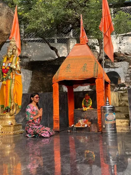 A traveler in prayer at the Anjanadri Hill temple in Hampi.