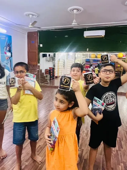 Everyone raising their branded mugs. It’s a small token, but it helps them feel like they are part of the Yog Mantra family.