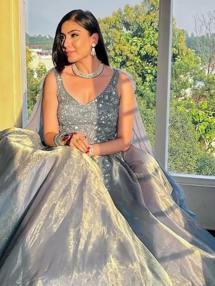 Another shot of the client by the window, showing how the gown's fabric glows in the sunlight.