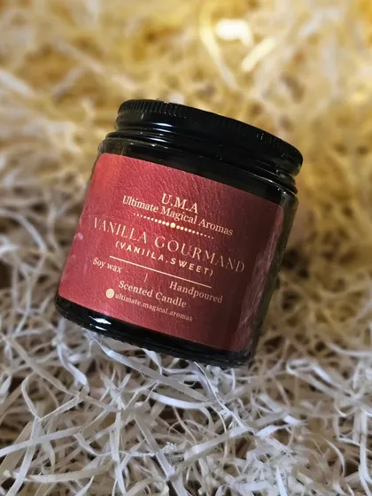 A close-up of the 'Vanilla Gourmand' candle, nestled in soft packing material. It’s a perfect companion for cozy moments, ready to elevate your space.
