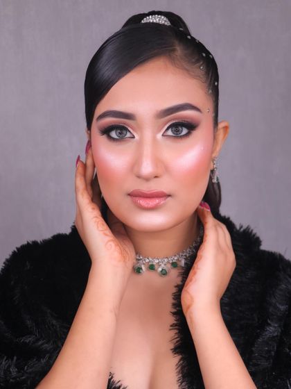 Hello Gorgeous. This glam party look, created by one of our students, features a soft pink smokey eye, sharp liner, and a radiant highlight.