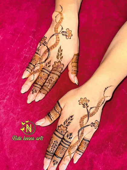 A different pose showing the elegant vine design. The pattern looks like a delicate piece of jewelry on the hands.