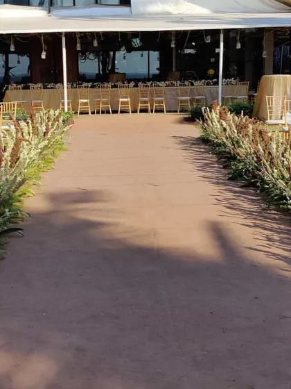 A simple and natural aisle for a rustic beach wedding. We lined the path with wild pampas grass and other dried florals, creating an earthy and beautiful walkway to the mandap.