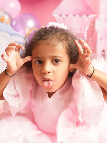Even princesses have a silly side. This fun and cheeky portrait captures the true personality of this little girl amidst the fairytale setting, a reminder that the best photos are the real ones.