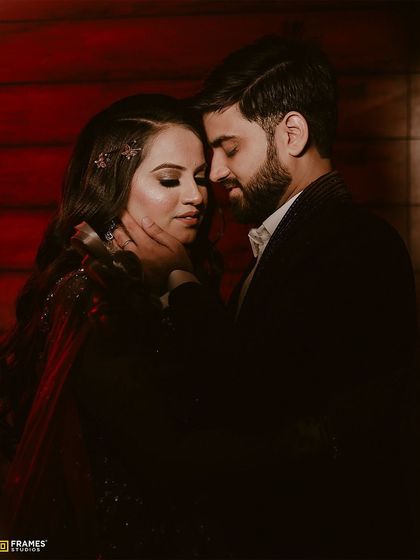 An intimate shot of a couple. The groom's simple, well-fitted suit jacket allows the moment to shine.