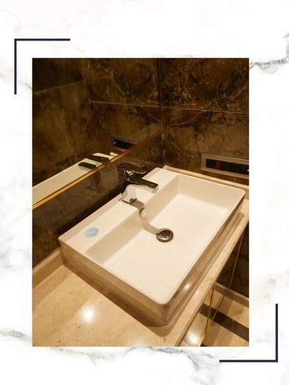 A close-up of a modern vessel sink on a marble countertop, representing the serene and sophisticated experience we create in our homes.