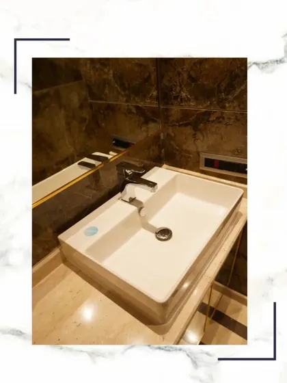 A close-up of a modern vessel sink on a marble countertop, representing the serene and sophisticated experience we create in our homes.