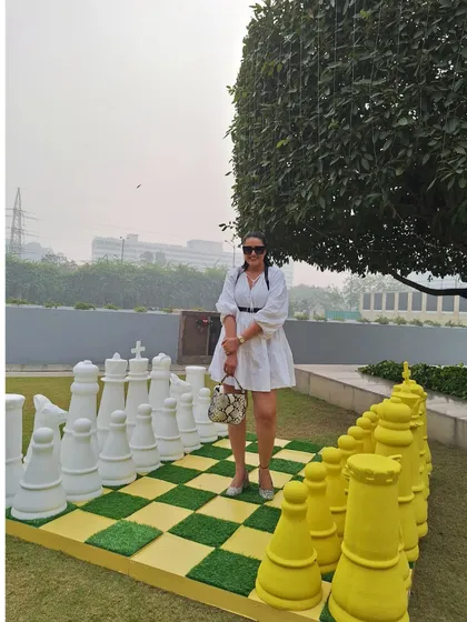 Ready for a game of chess? A fun shot from a Sunday brunch in a chic white dress and harness belt.