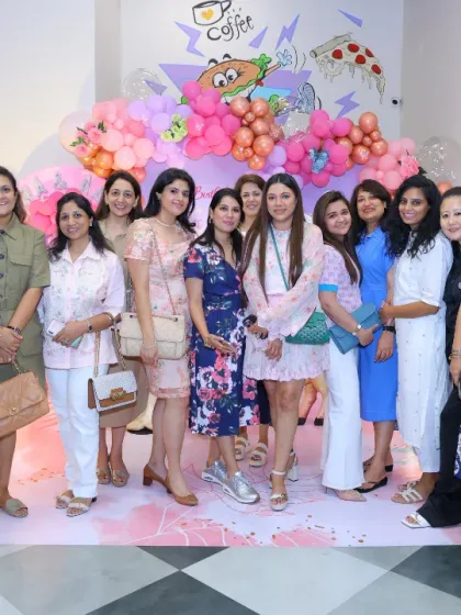 A group of stylish moms enjoying a get-together at a butterfly-themed birthday party. It's a great venue for social gatherings.