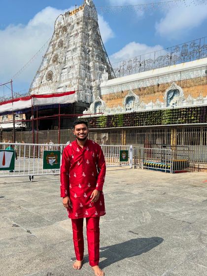 The same client posing in his red embroidered kurta. The intricate work and rich color make it a standout piece.