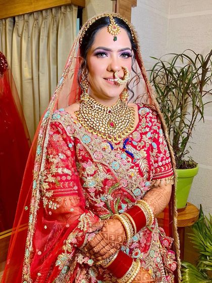 Another portrait showing the beautiful harmony between the makeup, the heavy jewelry, and the colorful embroidery of the lehenga.