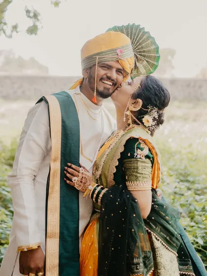 A playful and joyous moment from a traditional Maharashtrian shoot. The bride's spontaneous kiss on the groom's cheek and his wonderful laugh make this a perfectly candid and heartwarming shot.